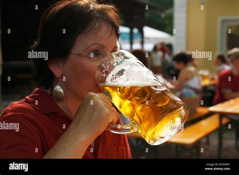 Woman drinking a litre of beer, Beer Garden at the Flaucher ...