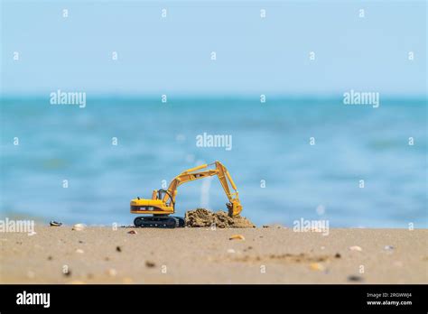 Caterpillar Model Excavator On Sandy Sea Shore Stock Photo Alamy