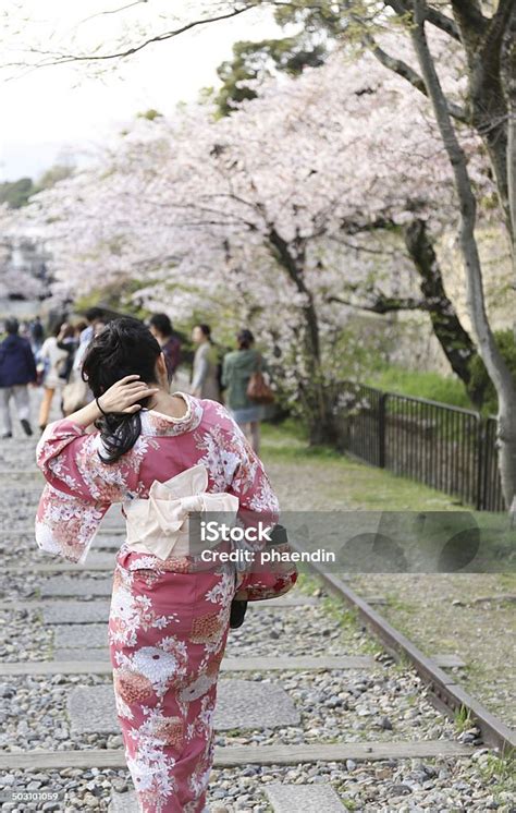 Japanese Girl In Traditional Dress Called Kimono With Sakura Blo Stock