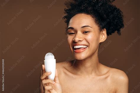Outgoing Multiracial Woman Preparing To Applying Antiperspirant On Her Body Naked Shoulders