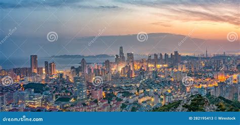 Night Skyline Of Qingdao Shandong Province In China Illuminated By A