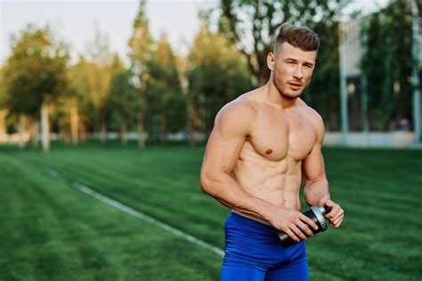 Premium Photo Portrait Of Shirtless Man Standing In Park