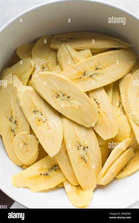 Slices Of Ripe Plantains In A White Bowl Slices Of Yellow Plantains