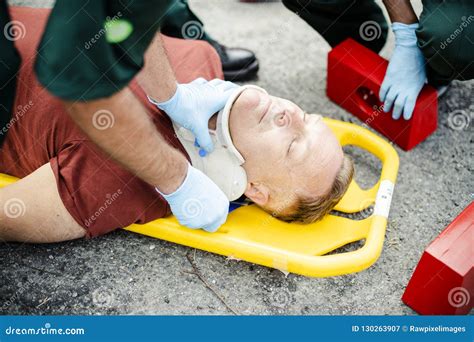 Paramedic Team Placing A Cervical Collar To An Injured Man Stock Image