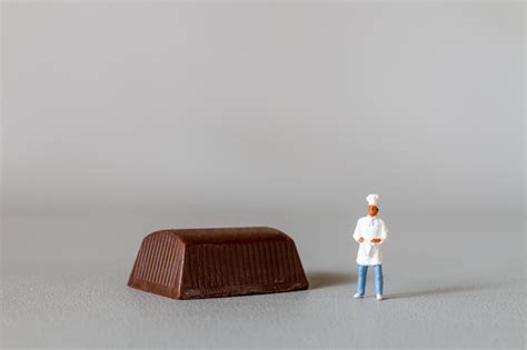 Premium Photo Miniature People Chef With Chocolate Standing While