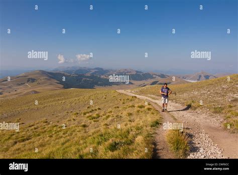 Hiker Climbing Monte Vettore At An Elevation Of 2478m 8130ft In The