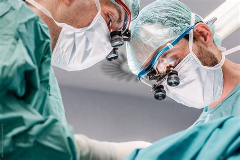 Doctors In Masks With Professional Magnifying Glasses Del Colaborador