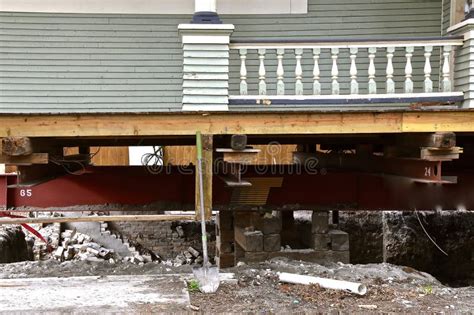 Old House Resting on Girders and Timbers Stock Photo - Image of excite ...