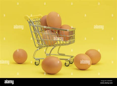 Raw Chicken Eggs In A Basket On A Yellow Background Eggs In A Metal