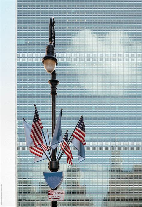 New York Street Lamp With American Flags Against United Nations