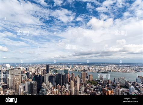 Manhattan Skyline And White Clouds On A Blue Sky View Towards East