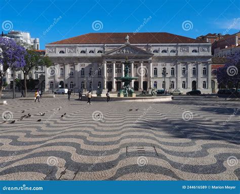 Rossio Square In Lisbon In Portugal With Purple Blooming Jacaranda