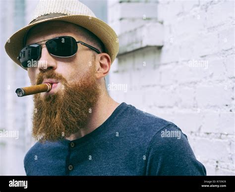 Bearded Man With Sunglasses Smoking A Cigar Stock Photo Alamy