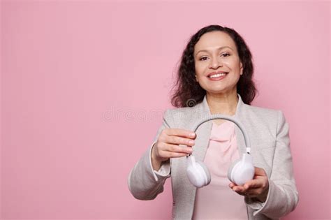 Mature Happy Pregnant Woman Pointing At Her Belly Holding The Ultrasonography Of Her Baby