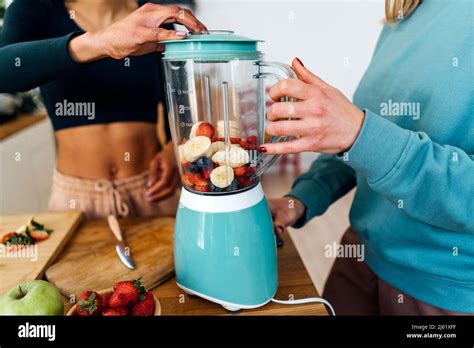 Friends Blending Fruits In Blender At Home Stock Photo Alamy