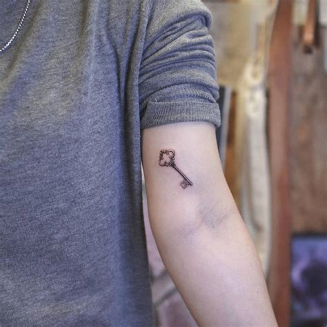 Micro Realistic Style Key Tattoo Located On The Inner