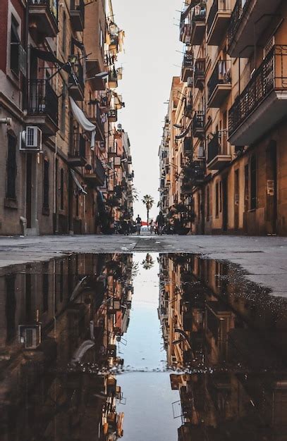 Premium Photo Reflection Of Buildings In Puddle On Street