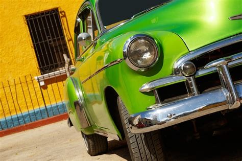 Premium Photo Front View Of A Shiny Vintage Green Car Parked On Street