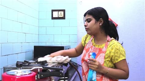 Indian Housewife Doing Housework Washing Bath Towels In Laundry Room