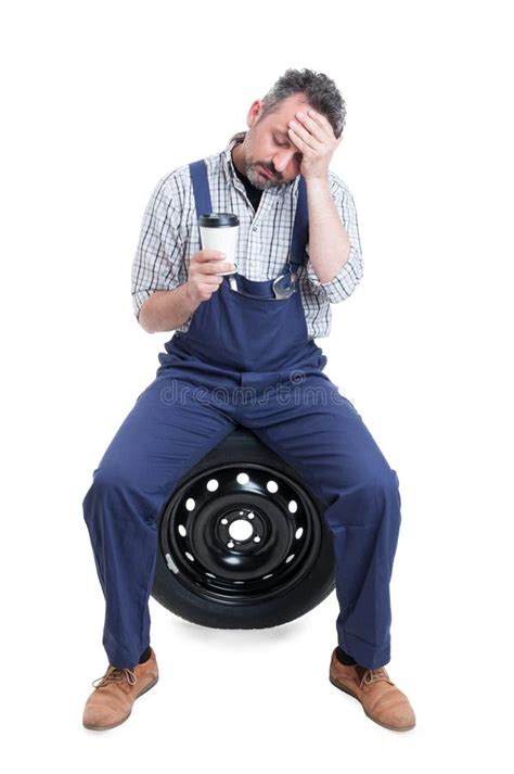 Mechanic Sitting On Car Wheel Isolated On White Stock Photo Image Of