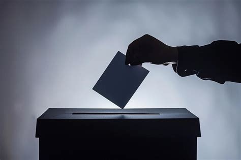 Hand Casting Vote Into Ballot Box Premium Ai Generated Image