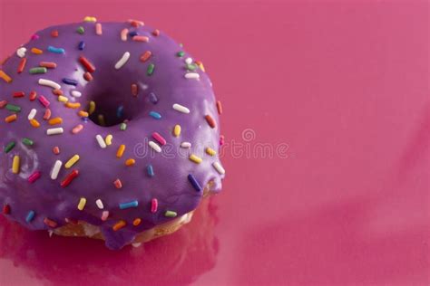 Purple Glazed Donut with Rainbow Sprinkles on Top Stock Image - Image ...