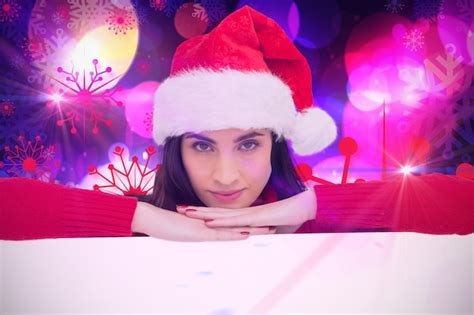 Premium Photo Pretty Brunette In Santa Hat Smiling At Camera Against