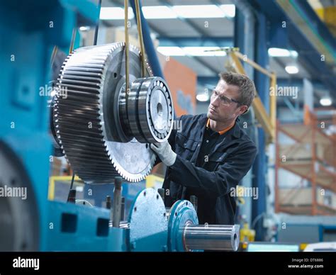 Engineer Assembling Industrial Gearbox In Engineering Factory Stock