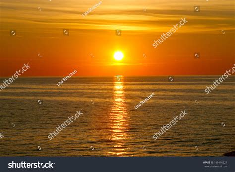 Beautiful Golden Orange Sunset Over Ocean Stock Photo 195416627