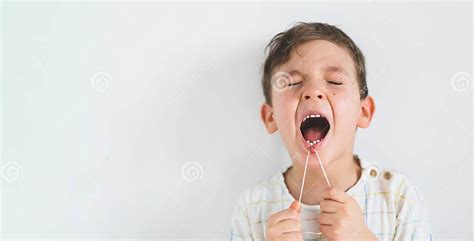 Cute Boy Pulling Loose Tooth Using A Dental Floss Process Of Removing