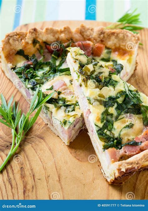 Quiche Lorraine Pie With A Smoked Bacon Cheese And Spinach Stock