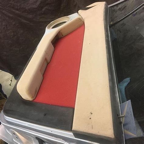 The Back End Of An Old Car That Has Been Painted Red And White