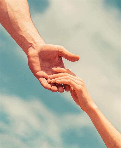 Premium Photo Couple Of Helping And Praying Hand On Sky Background Giving A Helping Hand