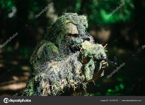 Sniper wears ghillie suit Stock Photo by ©Tverdohlib.com 131754172