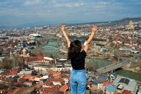 A Cute Brunette Girl Enjoys The Stunning Scenery Of Tbilisi From The Hill The Whole City At Her