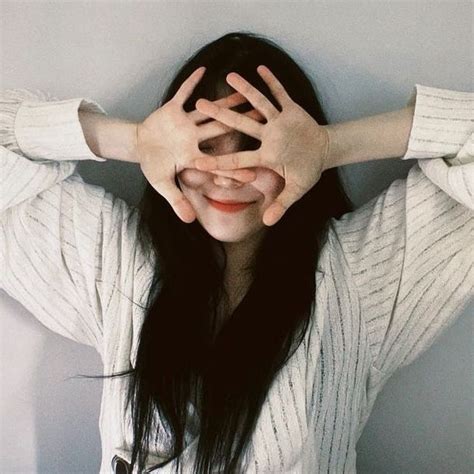 A Woman Covering Her Eyes With Both Hands