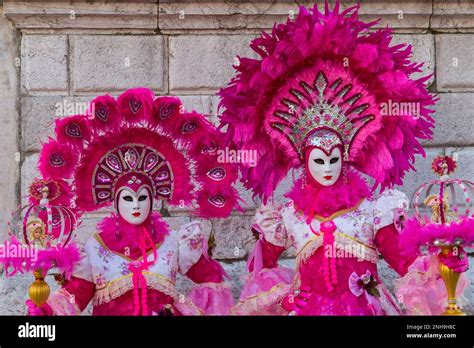 Carnival Goers Dressed In Splendid Pink Dresses Costumes And Masks During Venice Carnival 2023