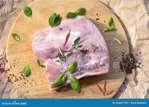 Fresh Raw Pork Chops On A Cutting Board On The Wrapping Paper Stock