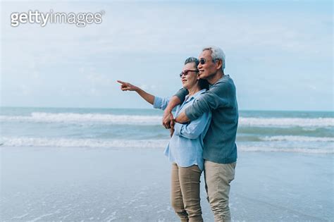 Asian Couple Senior Elder Retire Resting Relax At Beach Honeymoon