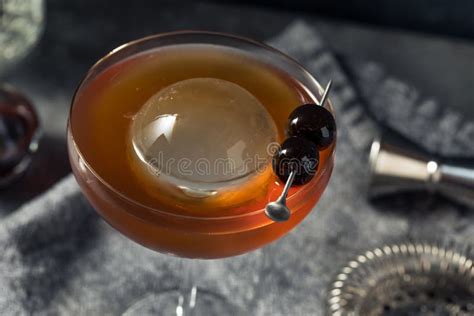 Boozy Cold Manhattan Cocktail with a Big Ice Cube Stock Photo - Image of party, liquor: 231546766