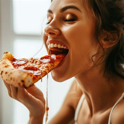 A Woman Is Eating A Slice Of Pizza With Pepperoni On It Premium Ai