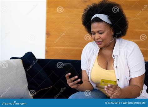 Happy Plus Size African American Woman On Sofa Online Shopping With