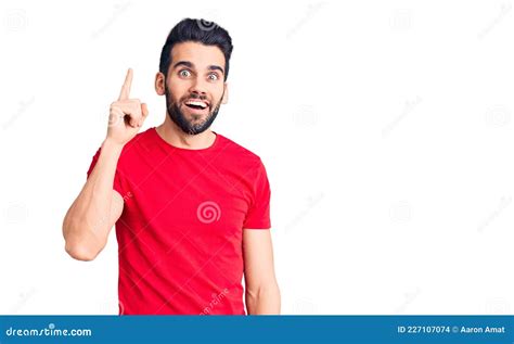 Young Handsome Man With Beard Wearing Casual T Shirt Pointing Finger Up