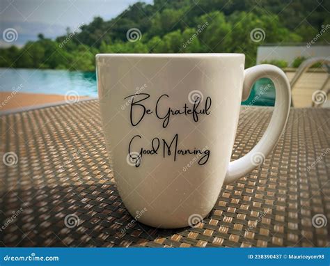Be Grateful And Good Morning Text On A Coffee Mug With Swimming Pool