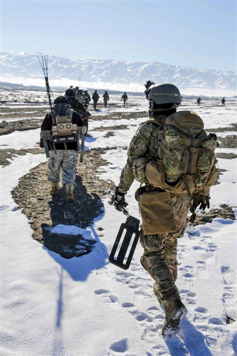 Us Special Forces Soldiers Follow Afghan Forces During A Clearing