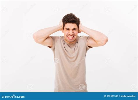 Photo Of Distressed Emotional Man 30s Grabbing His Head Or Cover Stock