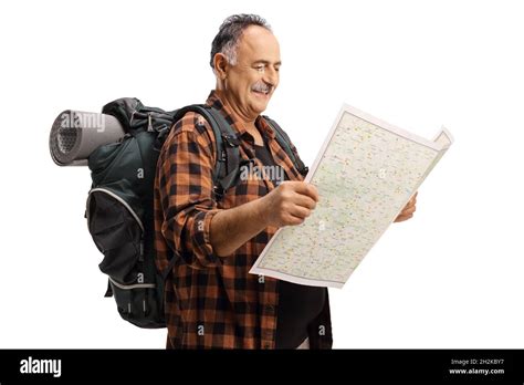 Happy Mature Hiker Looking At A Map And Smiling Isolated On White