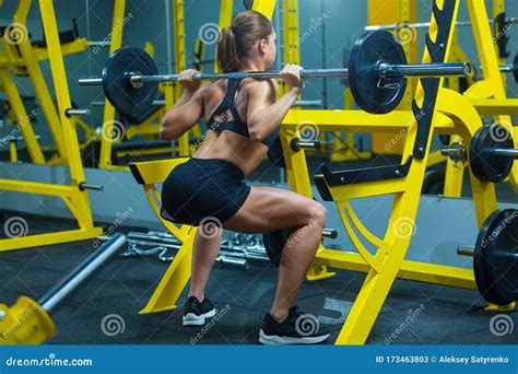 Back View Of A Young Fitness Woman Doing Barbell Squats In A Gym Stock Image Image Of Female