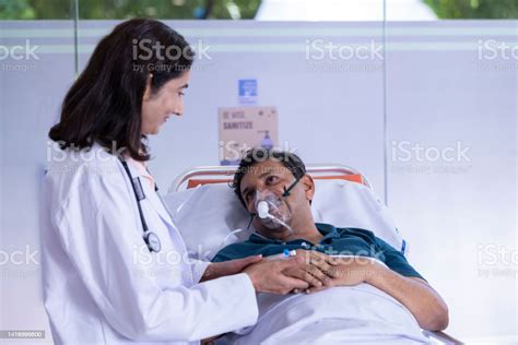 Doctor Scolding With Patient Lying On Stretcher Bed Stock Photo