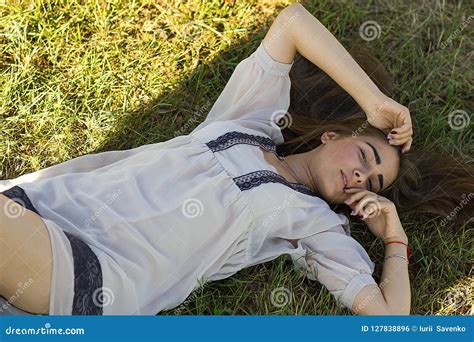 Beautiful Young Woman In White Dress Lying On Grass Stock Photo Image